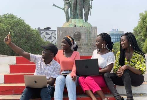 Young people learning with laptops in a community
